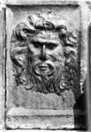 Rilievo testa virile con barba e capigliatura scomposte
